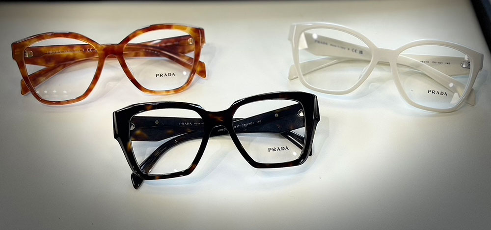 Three pairs of glasses with different frame styles, colors, and patterns displayed on a white surface.