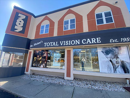 The image shows a storefront with the sign Total Vision Care and an advertisement for eyeglasses.