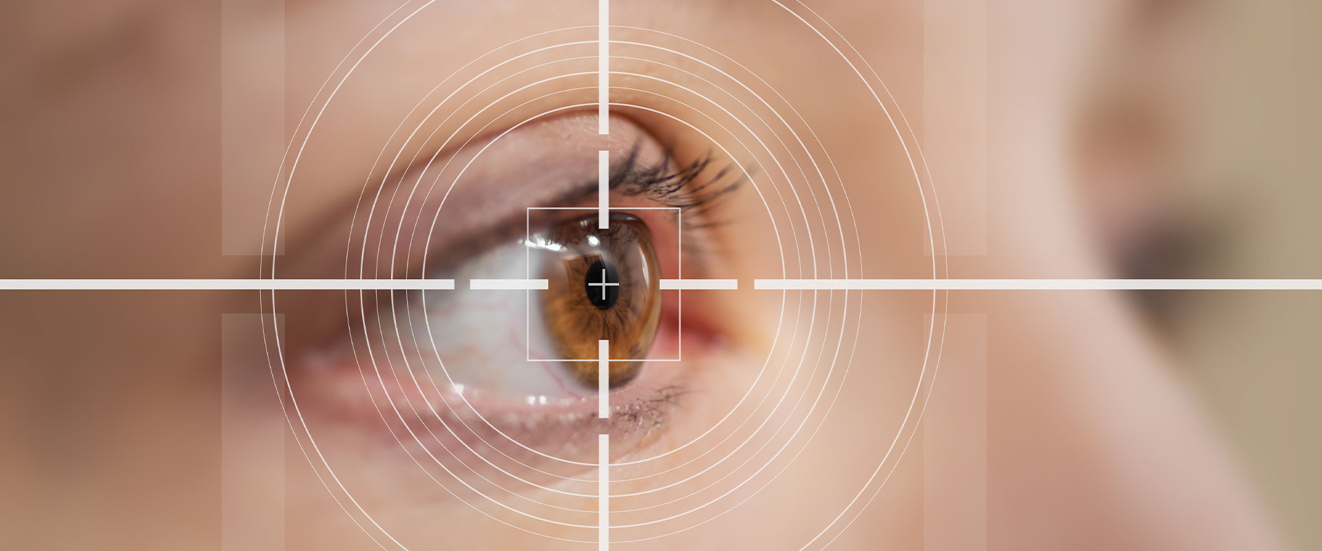 An image of a close-up view of an eye with a red reflex, viewed through a magnified lens, placed within a transparent circle with a crosshair design.