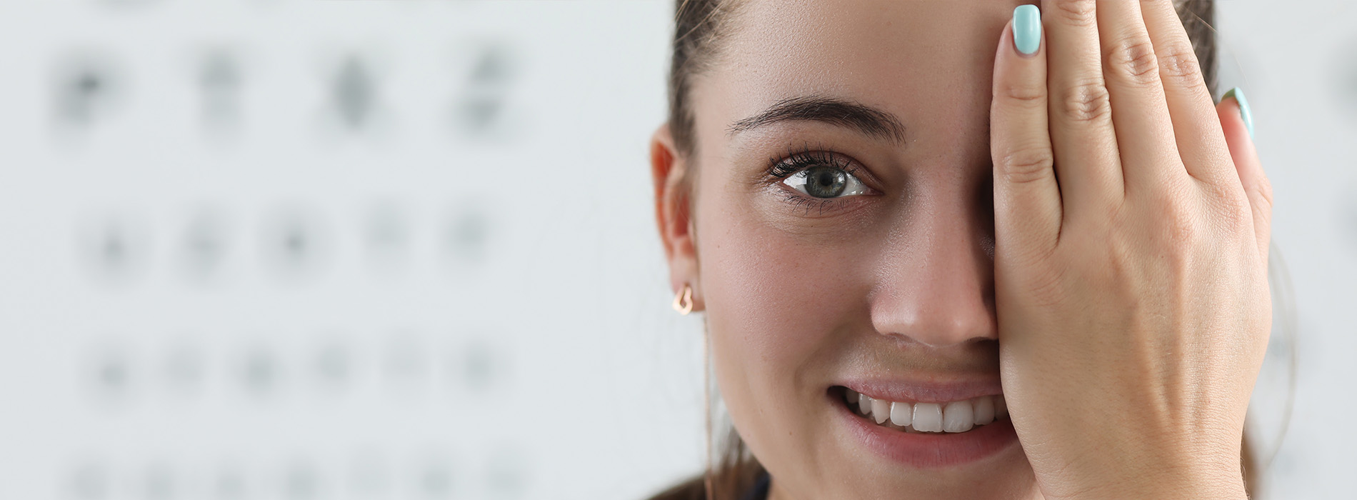 The image shows a woman with her hand placed over her eye, appearing to be in an optometrist s office.