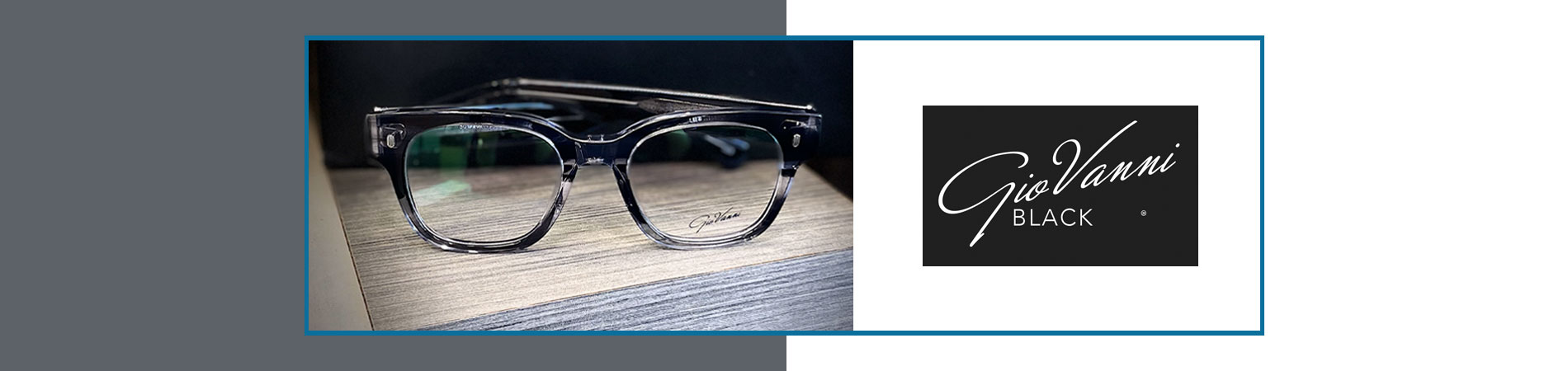 The image shows a pair of sunglasses placed in front of a black and white sign with the text Veni on it, against a blurred background that appears to be an interior space.